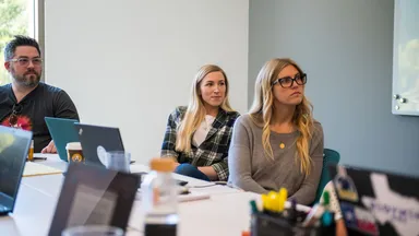 Three colleagues in a corporate work meeting