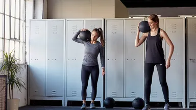 2 women holding med balls