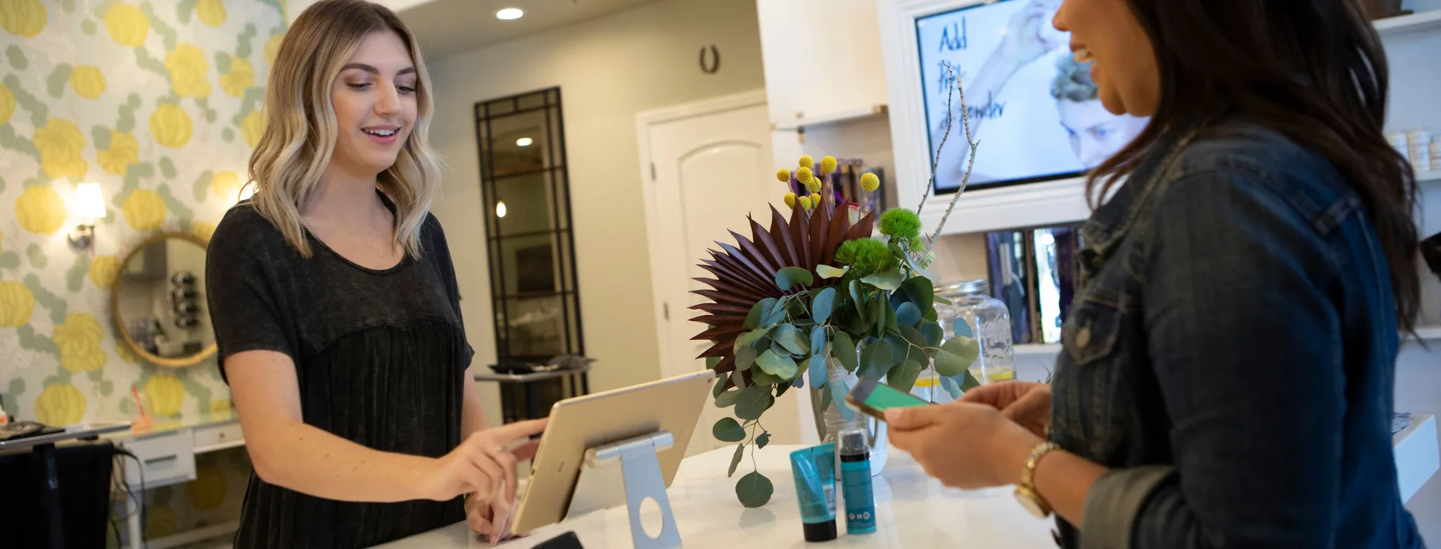 woman at checkout paying at salon