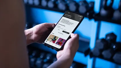 A photo of a phone showing a Mindbody branded mobile app