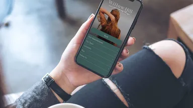 A woman holds a mobile phone