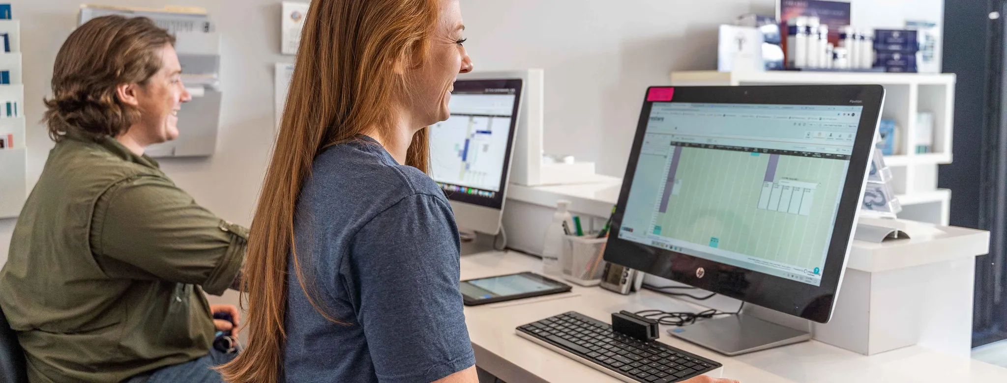 Two employees at the front desk