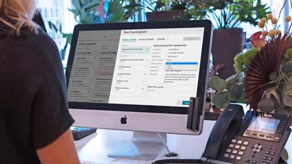 A staff member using Mindbody software for lead management.