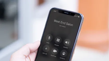 A photo of a mobile phone in someone's hand