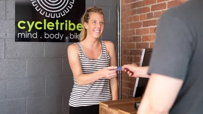 Person taking payment from client at front desk
