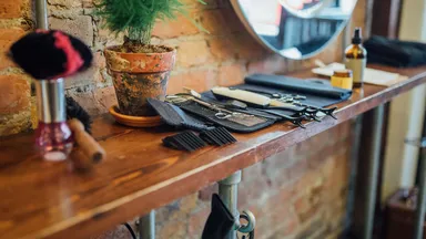 table at salon with salon tools plant and hair dryer