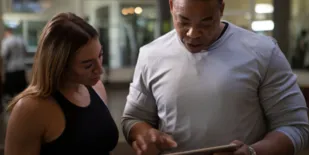 man and woman on ipad tablet