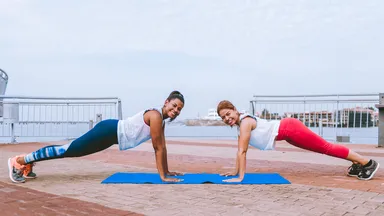 two women working out together outside