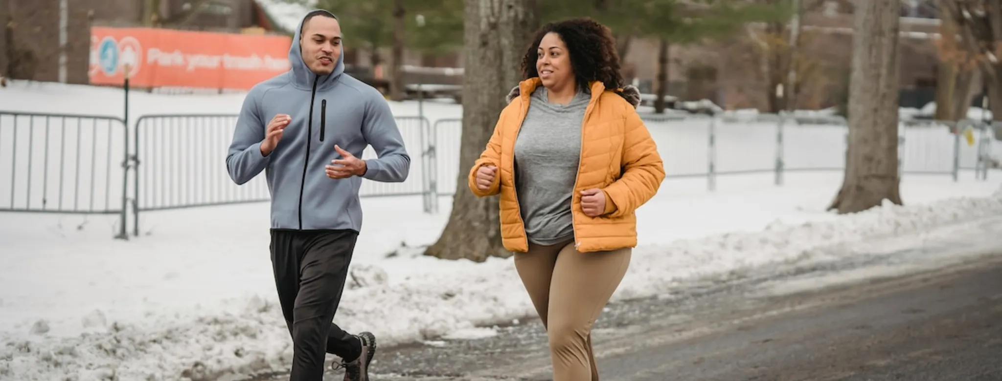 Two people working out outside.