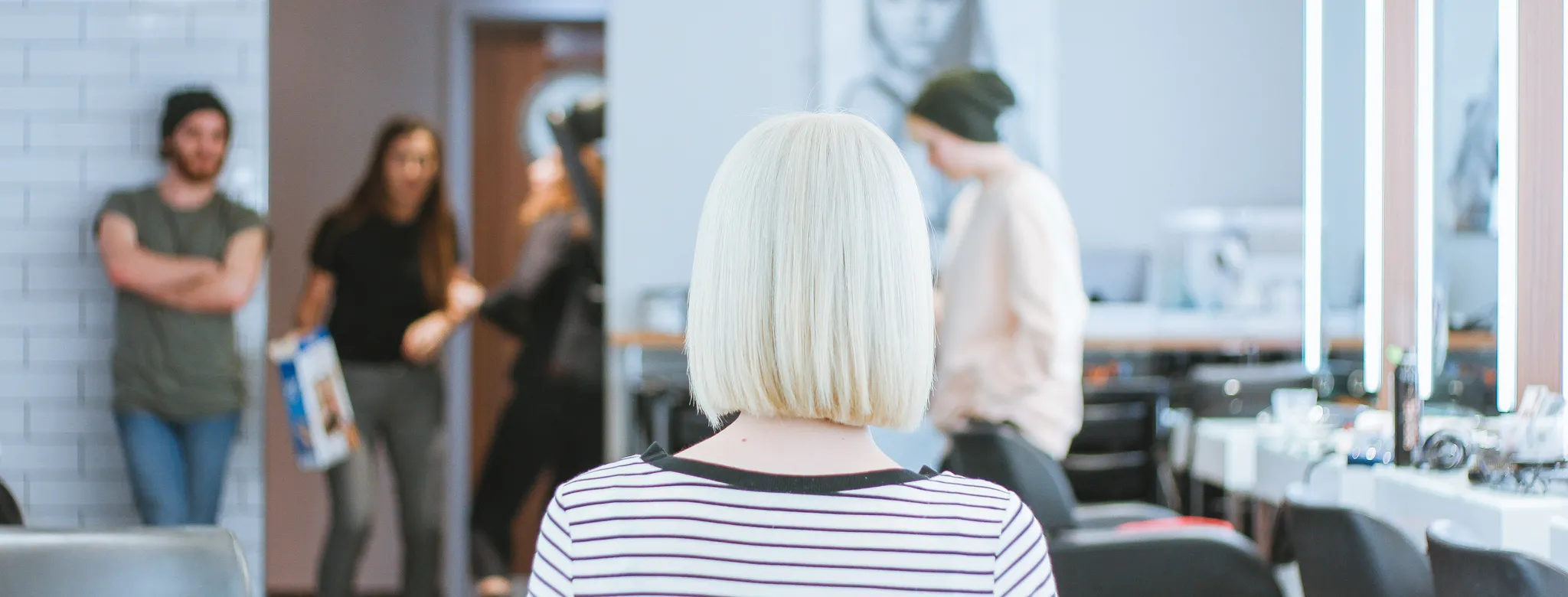 woman with platinum hair sitting in a salon 